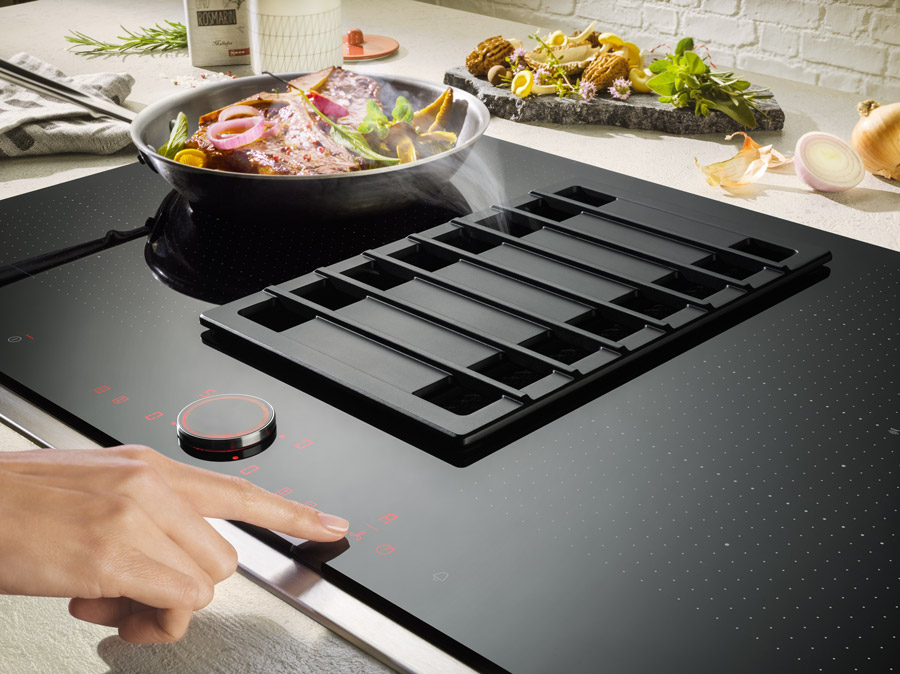 Venting hob integrated into a kitchen island