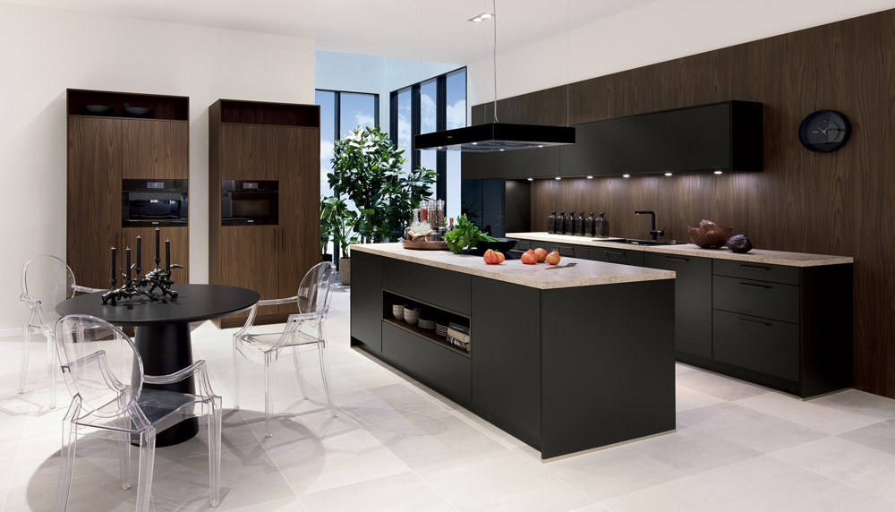 Dark timber and black handleless kitchen with an island